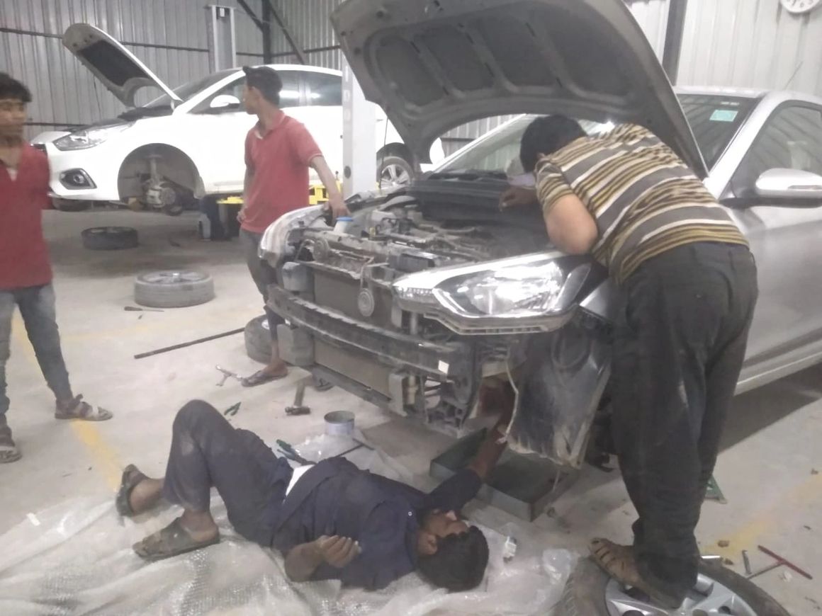 Mechanic checking engine oil levels during Mars Auto Care car service
