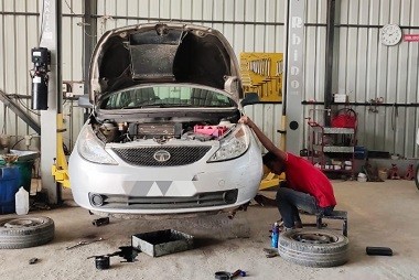 Mechanic checking engine oil levels during Mars Auto Care car service