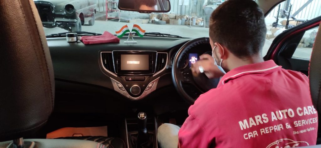 Car interior vacuum and dashboard cleaning by Mars Auto Care technicians