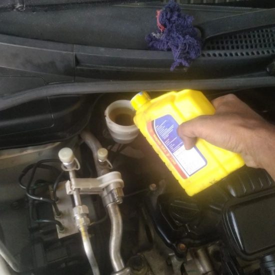 Mechanic checking engine oil levels during Mars Auto Care car service