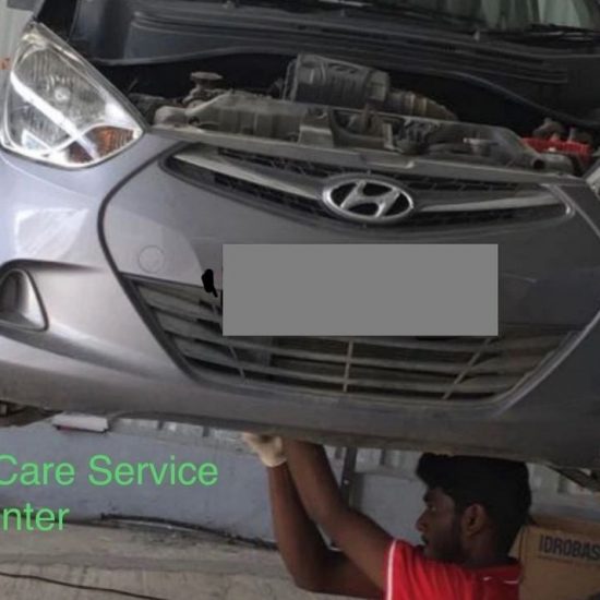 Mechanic checking engine oil levels during Mars Auto Care car service